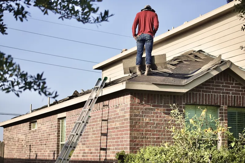 Professional roofer working on a residential roof in Fort Howard